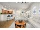Bright living room with modern furniture, opening to the kitchen with breakfast bar, and dining area at 11000 N 77Th Pl # 2042, Scottsdale, AZ 85260