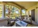 Inviting covered patio features comfortable seating, a golf course view, and elegant architectural details at 11000 N 77Th Pl # 2042, Scottsdale, AZ 85260