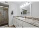 Bathroom featuring a granite countertop vanity and a glass enclosed shower with tile surround at 1216 E Rowlands Ln, Phoenix, AZ 85022