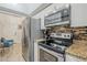 Well-equipped kitchen with stainless steel appliances, mosaic backsplash, and modern fixtures at 1216 E Rowlands Ln, Phoenix, AZ 85022