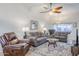 Comfortable living room featuring tile floors, a ceiling fan, and well-coordinated furniture at 1216 E Rowlands Ln, Phoenix, AZ 85022