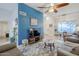 Spacious living room with accent wall, tile flooring, and dining area at 1216 E Rowlands Ln, Phoenix, AZ 85022