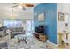 Bright living room showcasing an accent wall, tiled floors, and access to the outdoor area at 1216 E Rowlands Ln, Phoenix, AZ 85022
