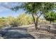 Paved community pathway with bench seating surrounded by desert landscape at 1216 E Rowlands Ln, Phoenix, AZ 85022