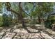 Landscaped backyard featuring flagstone, mature trees, and desert plants, offering a tranquil outdoor space at 1243 W Sherri Dr, Gilbert, AZ 85233