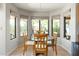 Bright breakfast nook featuring a glass top table, seating for four and three large windows offering natural light at 1243 W Sherri Dr, Gilbert, AZ 85233