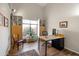 Well-lit home office featuring a large window, built-in shelves, and a modern desk with wood flooring at 1243 W Sherri Dr, Gilbert, AZ 85233