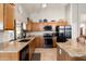 Bright eat-in kitchen featuring granite counters, stainless appliances, wood cabinets and backyard views at 1243 W Sherri Dr, Gilbert, AZ 85233