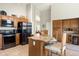 Eat-in kitchen showcases stainless steel appliances, wood cabinets and a granite island with bar seating at 1243 W Sherri Dr, Gilbert, AZ 85233