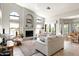 Bright living room with vaulted ceilings, fireplace, arched windows, and comfortable seating at 1243 W Sherri Dr, Gilbert, AZ 85233