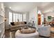 Bright living room featuring neutral tones, vaulted ceiling, modern furniture, and a dark-stained wood floor at 1243 W Sherri Dr, Gilbert, AZ 85233