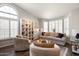 Open-concept living room with a decorative built-in shelf, modern furniture, and large windows at 1243 W Sherri Dr, Gilbert, AZ 85233