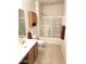 Well-lit bathroom with vanity, wood cabinets, shower over tub, and neutral decor at 1265 S Aaron -- # 299, Mesa, AZ 85209