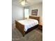 Bright bedroom showcasing wood frame bed, carpet floor, ceiling fan, and white walls at 1265 S Aaron -- # 299, Mesa, AZ 85209