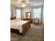 Bedroom features wood frame bed, carpet floor, ceiling fan, and bright natural lighting at 1265 S Aaron -- # 299, Mesa, AZ 85209