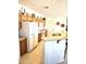 Well-lit kitchen with a breakfast bar, offering both tile and carpeted flooring at 1265 S Aaron -- # 299, Mesa, AZ 85209