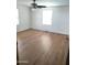 Bright, spacious bedroom with wood-look floors, neutral paint, and a ceiling fan offering comfort at 127 S 75Th Pl, Mesa, AZ 85208