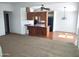 Bright living room featuring a ceiling fan, an open kitchen, carpeted floors, and light neutral walls at 127 S 75Th Pl, Mesa, AZ 85208