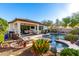 Beautiful backyard with pool, spa, covered patio, and lush landscaping, perfect for entertaining at 12798 W Dove Wing Way, Peoria, AZ 85383
