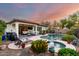 Picture of the peaceful backyard with a sparkling pool, covered patio, and manicured landscaping at 12798 W Dove Wing Way, Peoria, AZ 85383
