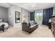 Spacious bedroom with a comfortable couch, a bed and a view of the connected bathroom at 12798 W Dove Wing Way, Peoria, AZ 85383