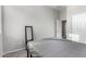 Simple, comfortable bedroom with a gray upholstered bed, and neutral walls at 12798 W Dove Wing Way, Peoria, AZ 85383