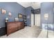 Neutral carpeted bedroom with wood dresser and shelving, offering ample closet space at 12798 W Dove Wing Way, Peoria, AZ 85383