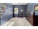 Cozy bedroom with navy blue walls and carpet flooring, adorned with themed decorations at 12798 W Dove Wing Way, Peoria, AZ 85383