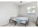 Well-lit bedroom with a queen bed, soft carpet, and a bright window at 12798 W Dove Wing Way, Peoria, AZ 85383
