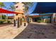 Stunning clubhouse entrance with modern architecture, stone accents, and colorful shade sails at 12798 W Dove Wing Way, Peoria, AZ 85383