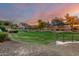 Lush community green space and walking path with mature trees, creating a park-like setting at 12798 W Dove Wing Way, Peoria, AZ 85383
