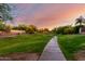 Scenic community walking path surrounded by lush landscaping and vibrant trees at 12798 W Dove Wing Way, Peoria, AZ 85383