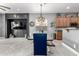 Bright dining area showcases a full view of the kitchen and a stylish modern chandelier above the table at 12798 W Dove Wing Way, Peoria, AZ 85383