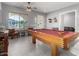 Entertaining game room showcases a pool table, ample seating, and seamless flow to other living areas at 12798 W Dove Wing Way, Peoria, AZ 85383