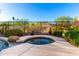 Inviting backyard spa and pool area surrounded by lush desert landscaping at 12798 W Dove Wing Way, Peoria, AZ 85383