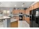 Well-lit kitchen boasts abundant wood cabinetry, stainless steel appliances, and smooth countertops at 12798 W Dove Wing Way, Peoria, AZ 85383