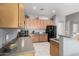 Bright kitchen features wooden cabinets, gray countertops, tile floor and a stainless steel sink at 12798 W Dove Wing Way, Peoria, AZ 85383