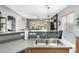 Modern kitchen with stainless steel sink, gray countertops and an open view to the living room at 12798 W Dove Wing Way, Peoria, AZ 85383