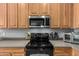 Modern kitchen showcases stainless steel appliances, smooth countertops, and stylish black range at 12798 W Dove Wing Way, Peoria, AZ 85383