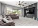 Comfortable living room features a large sectional sofa, media center, and sliding glass doors to the outdoors at 12798 W Dove Wing Way, Peoria, AZ 85383