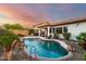 Beautiful backyard pool surrounded by lush landscaping, creating a private oasis at 12798 W Dove Wing Way, Peoria, AZ 85383