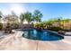 Backyard pool with stone waterfall feature and mature landscaping for added privacy at 12798 W Dove Wing Way, Peoria, AZ 85383