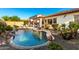 Inviting backyard pool and covered patio, perfect for relaxing and entertaining at 12798 W Dove Wing Way, Peoria, AZ 85383