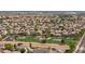 Community aerial view of houses near green common area with trees at 12936 W Flower St, Avondale, AZ 85392