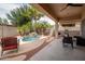 Outdoor patio with covered seating area and a private swimming pool with a waterfall at 12936 W Flower St, Avondale, AZ 85392