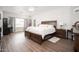 Spacious bedroom with wood floors, ceiling fan and white brick accent wall at 12936 W Flower St, Avondale, AZ 85392