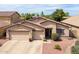 Charming single-story home featuring a tile roof, neutral stucco exterior, and a convenient two-car garage at 12936 W Flower St, Avondale, AZ 85392