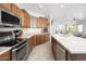 Well-equipped kitchen with stainless steel appliances, ample counter space, and tile flooring at 12936 W Flower St, Avondale, AZ 85392