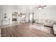 Open-concept living room and dining area featuring modern furnishings, wood laminate floors, and neutral decor at 12936 W Flower St, Avondale, AZ 85392