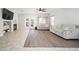 Open living space with fireplace, tile and wood laminate flooring and light gray color scheme at 12936 W Flower St, Avondale, AZ 85392